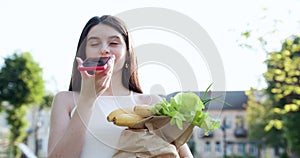 Happy girl using a smart phone voice recognition audio ai message speech function on line walking on a park background