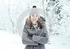 Happy girl walking in a beautiful winter forest