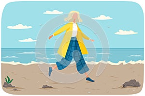 Happy girl walks along beach. Summer landscape in background with sand and water, outdoor activities