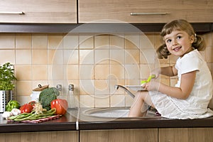 Happy girl washing dishes