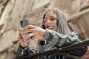 Happy girl watching internet social media in cell phone