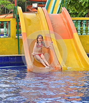 Happy girl on water slide