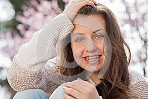 Happy girl wearing braces spring portrait