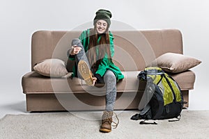 happy girl wearing hiking boots on sofa