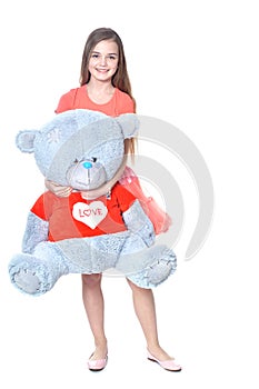 Happy girl wooth big blue teddy bear posing