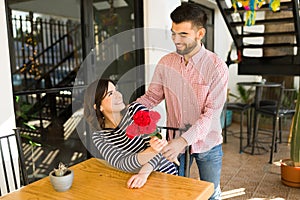 Happy girlfriend receiving a bouquet of flowers