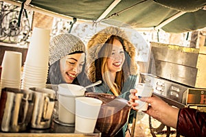 Happy girlfriends best friends having fun at coffee vendor