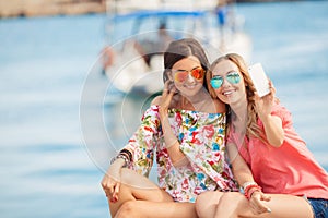 Happy girlfriends near the sea