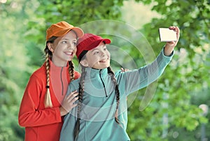 Happy girls with beauty look pose for selfie camera phone on natural landscape, self-portrait photograph