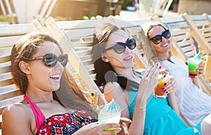 Happy girls with beverages on summer party