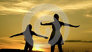 Happy girls dancing on the beach. party by the lake, children dancing. beautiful girls having fun listening to music