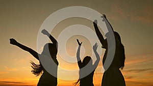 Happy girls dancing on the beach. Slow motion. party by lake, children dancing. beautiful girls having fun listening to