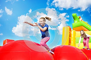Happy Girls on Inflate Castle Cloudscape photo