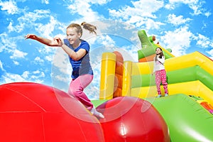 Happy Girls Jumping on Inflate Castle photo