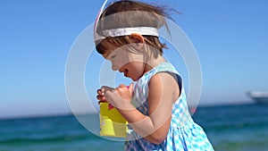 Happy girls playing with easter eggs on the beach