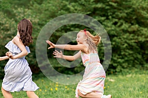 Happy girls playing tag game at birthday party