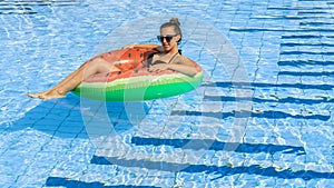 Happy girls pool. Young sexy woman in bikini swimsuit, sunglasses with inflatable rubber ring swimming in blue water