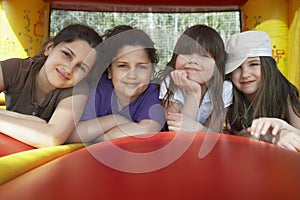 Happy Girls Relaxing In Bouncy Castle photo