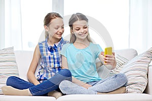 Happy girls with smartphone taking selfie at home