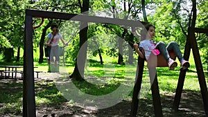 Happy girls swinging in the park, slow motion