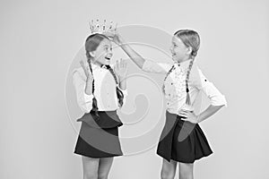 Happy girls in uniform and crown. imagine as big boss. motivation to study. kid fashion. Friendship. prom queen