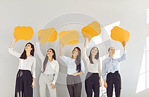 Happy girls, young female group of business people, friends holding empty paper speech bubbles