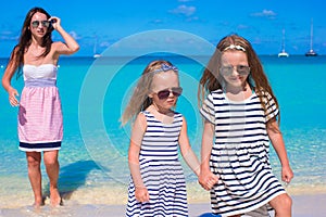 Happy girls and young mom during beach vacation