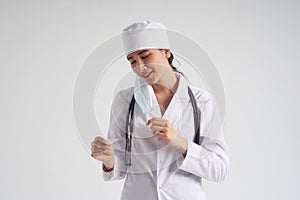Happy glad Doctor wearing face mask looking at measurement on medical thermometer over white background with copy space