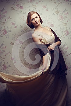 Happy glamorous red-haired girl in vintage dress