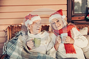 Happy glancing aged pair celebrating Christmas together photo