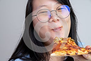 Happy glasses Asian young woman eat Pizza on white background