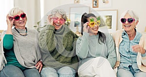 Happy, glasses and senior women face on the living room sofa for fun, playing and comedy. Smile, laughing and portrait