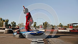 Happy go-cart driver raising hand up rejoicing and celebrating win