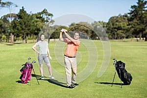 Happy golfer taking shot