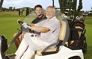 Happy golfers in golf cart