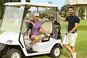 Happy golfers and golf cart