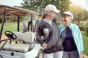 Happy golfers. a senior woman and her adult daughter enjoying a day on the golf course.