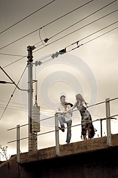 Happy good looking couple leaning on bridge railling