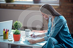 Happy good looking nice woman taking notes