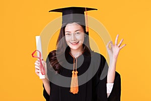 Happy Graduate asian woman in cap and gowm holding Certificated