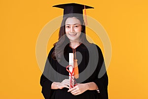 Happy Graduate asian woman in cap and gowm holding Certificated