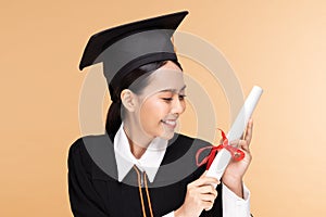 Happy Graduate asian woman in cap and gowm holding Certificated or diploma