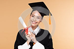 Happy Graduate asian woman in cap and gowm holding Certificated or diploma