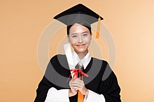 Happy Graduate asian woman in cap and gowm holding Certificated or diploma