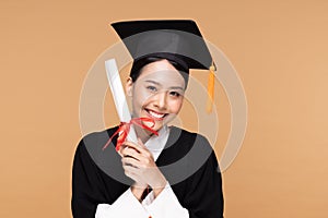 Happy Graduate asian woman in cap and gowm holding Certificated or diploma