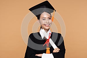 Happy Graduate asian woman in cap and gowm holding Certificated or diploma