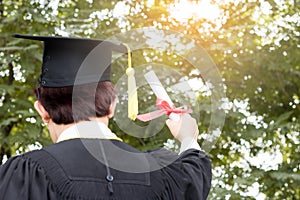 Happy graduate showing certificated in hand