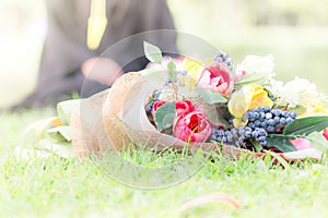 Happy graduate young Asian woman in cap and gown holding bouquet and certificated in hand, Education concept