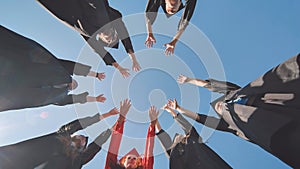 The happy graduates join hands and disperse.