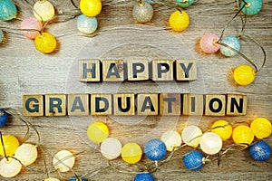 Happy Graduation alphabet letters with LED cotton balls decoration on wooden background